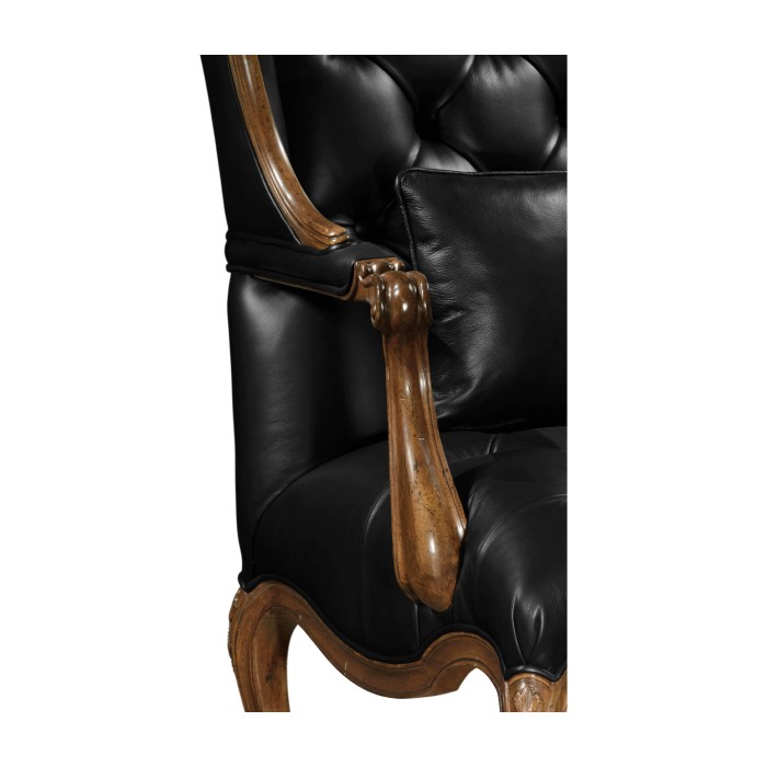Wing-backed chair in black leather